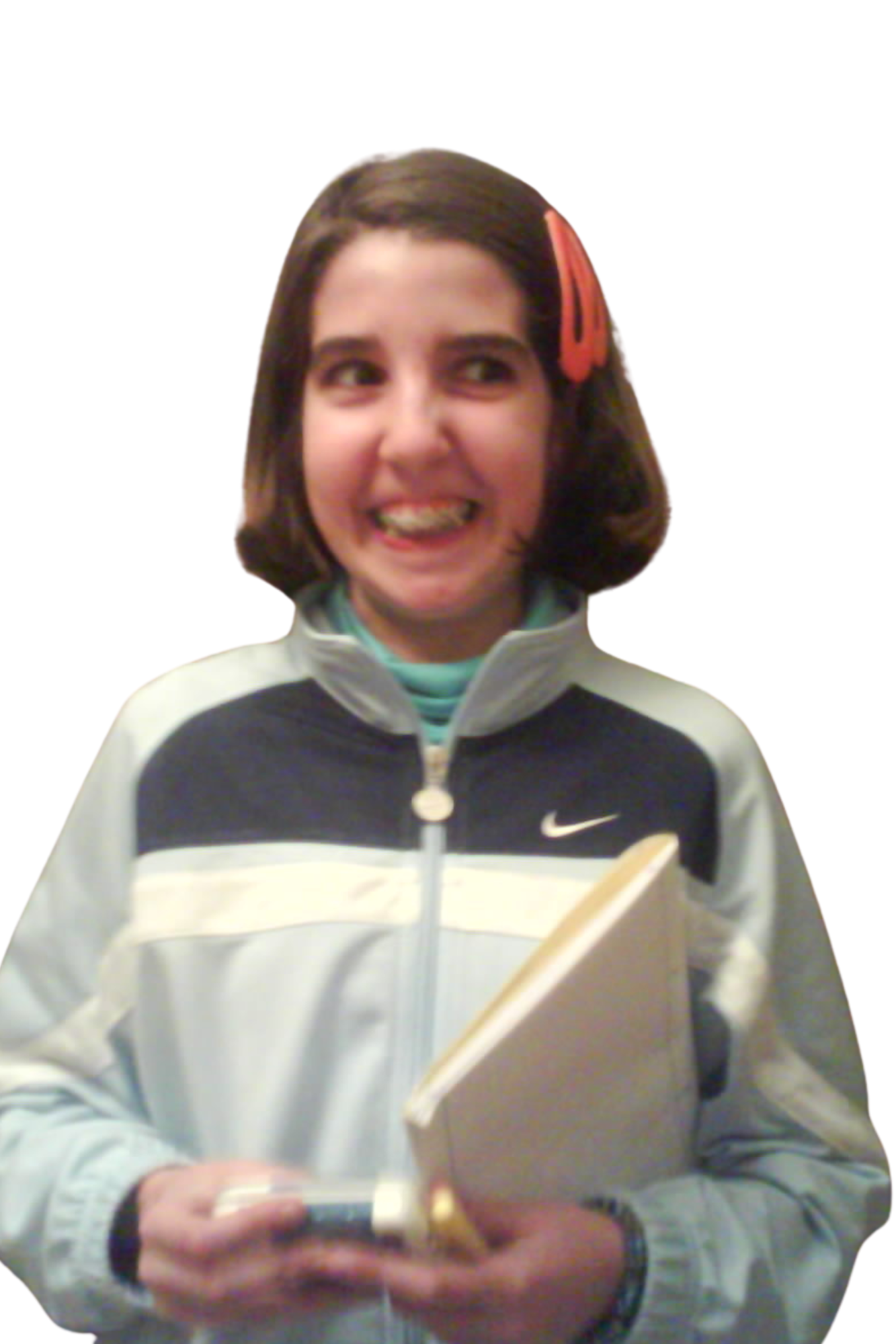 Inês as a kid in a Nike tracksuit, holding a book and laughing